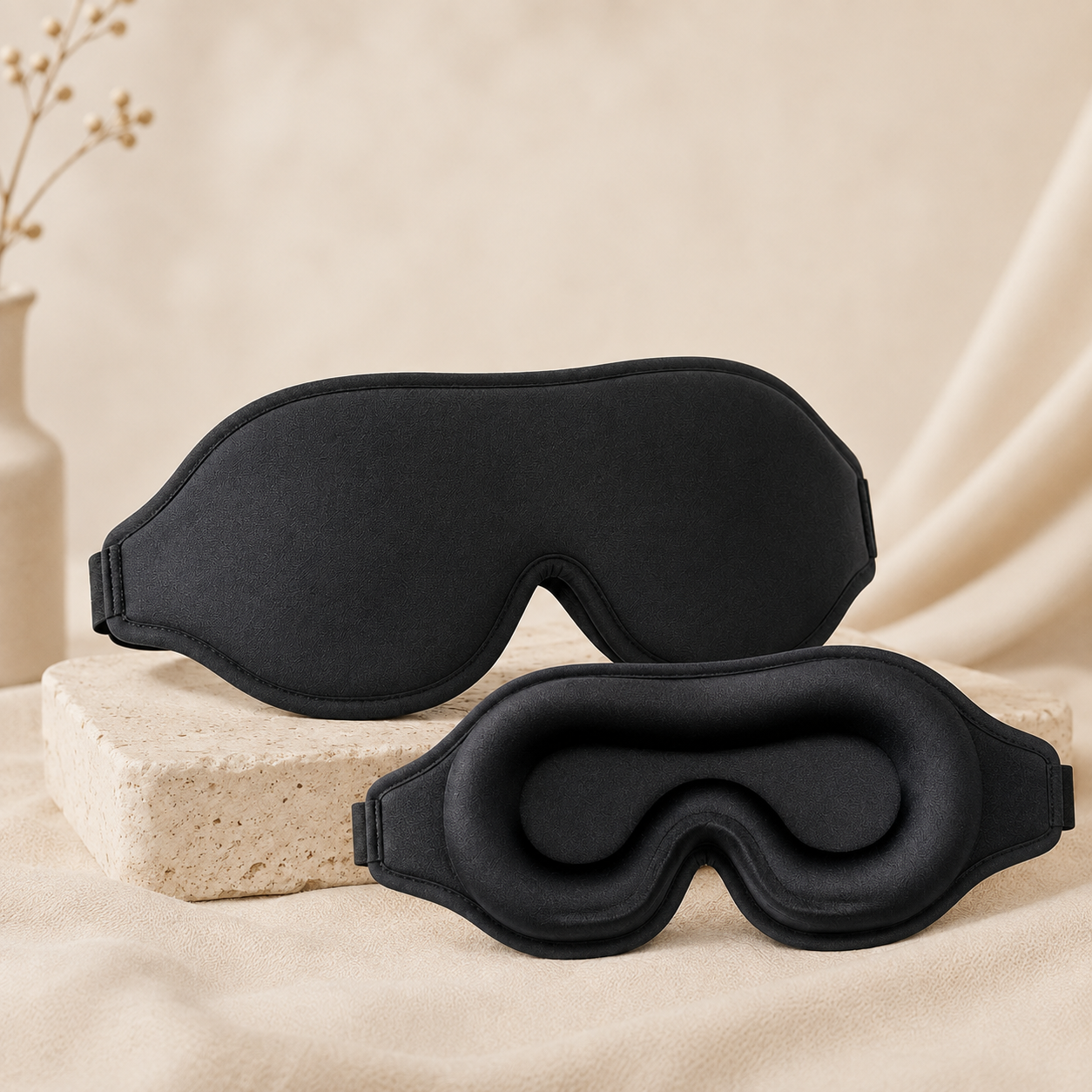 Black 3D contour sleep mask shown front and inner side on a soft beige background