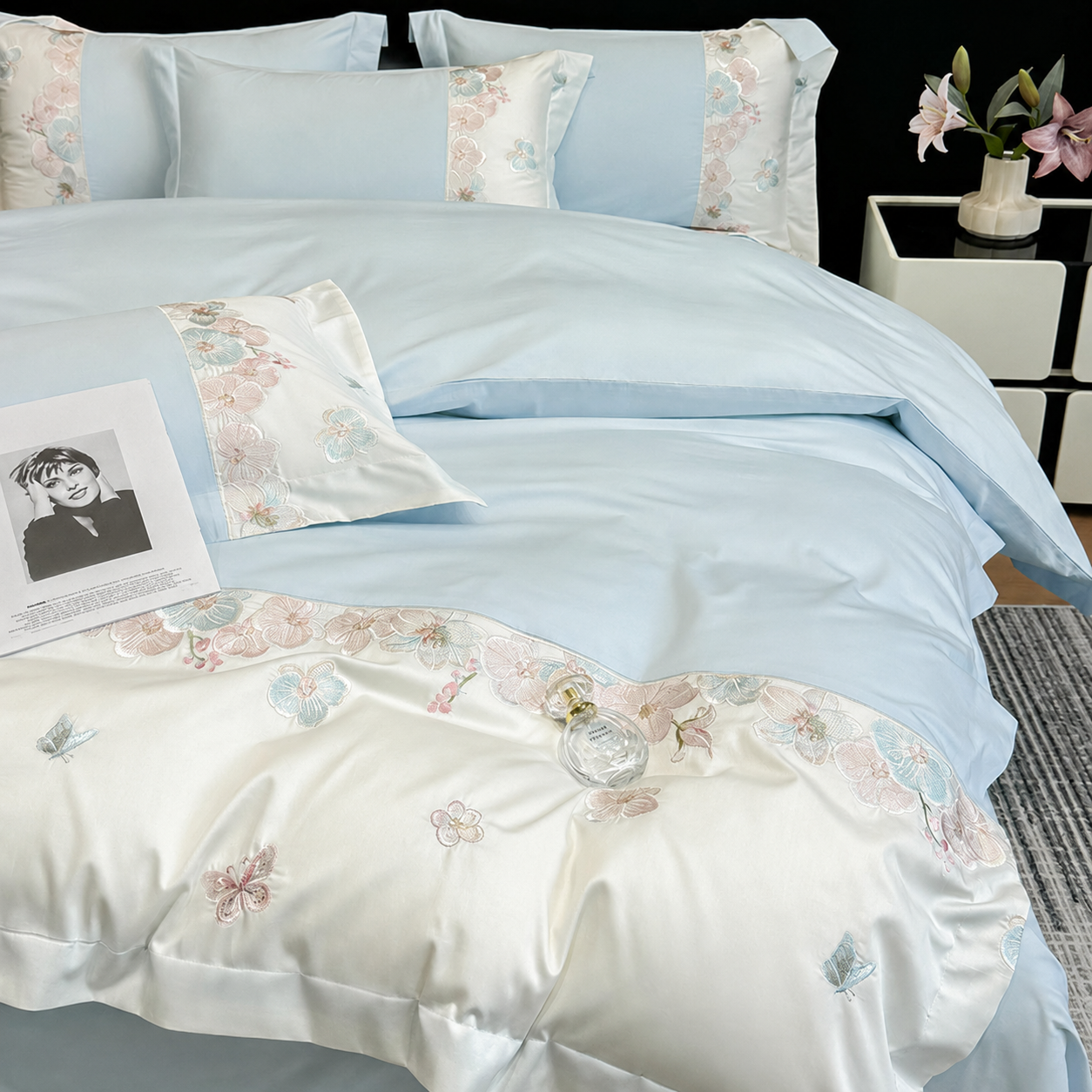 Light blue RestWeave bedding set with ivory panels and pastel floral embroidery